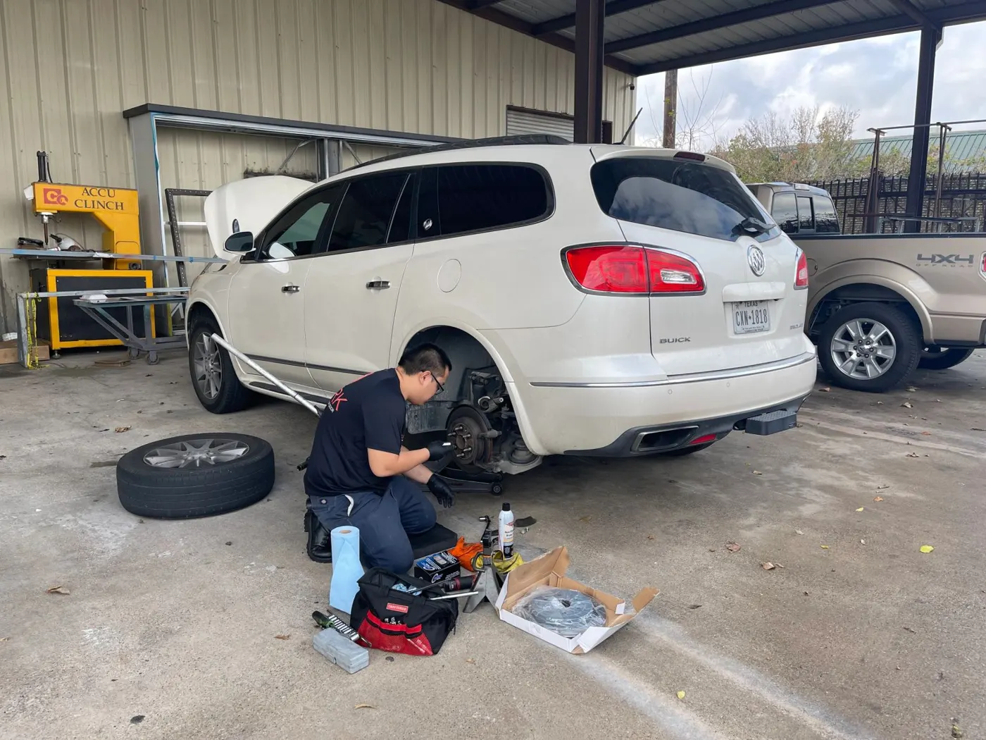 SPARK technician changing tires on a white SUV
